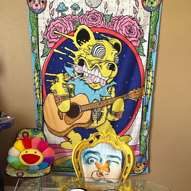 Colorful room interior with posters, a mirror, and decorative items on a wall.